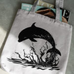 376_Dolphin_jumping_in_the_ocean_6127-transparent-tote_bag_1.jpg