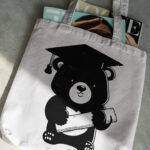 895_cute_bear_with_graduation_cap_cartoon_6095-transparent-tote_bag_1.jpg